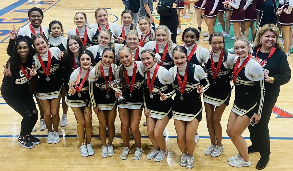 Cheerleaders and Coaches posing with their medals